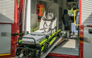 Inside view of a modern emergency ambulance showing a stretcher for patient transport.